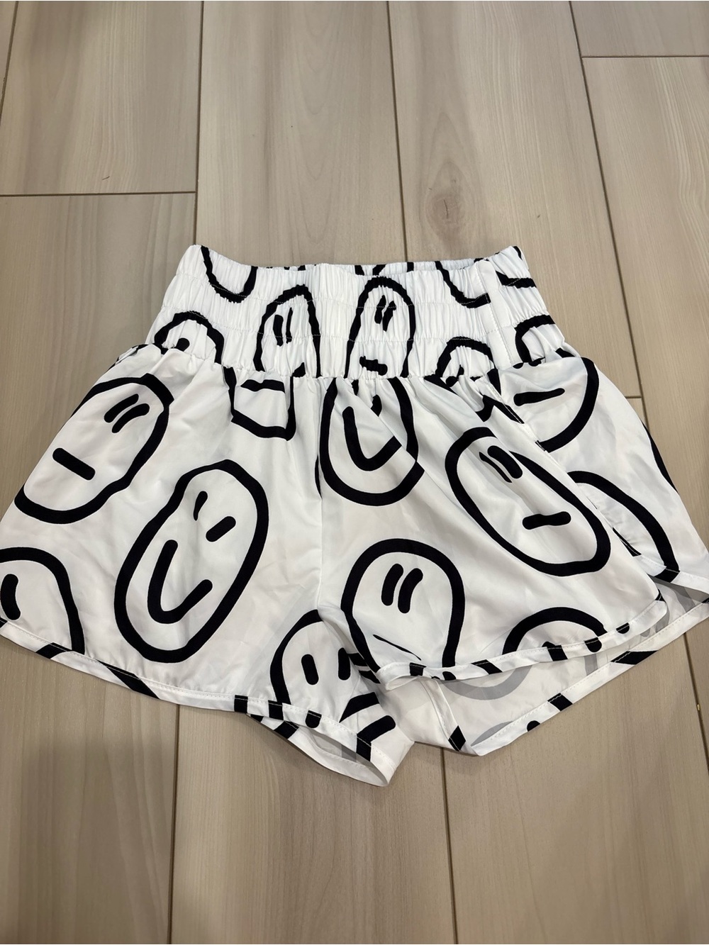 Main Strip White Athletic Shorts with Black Smiley Print
